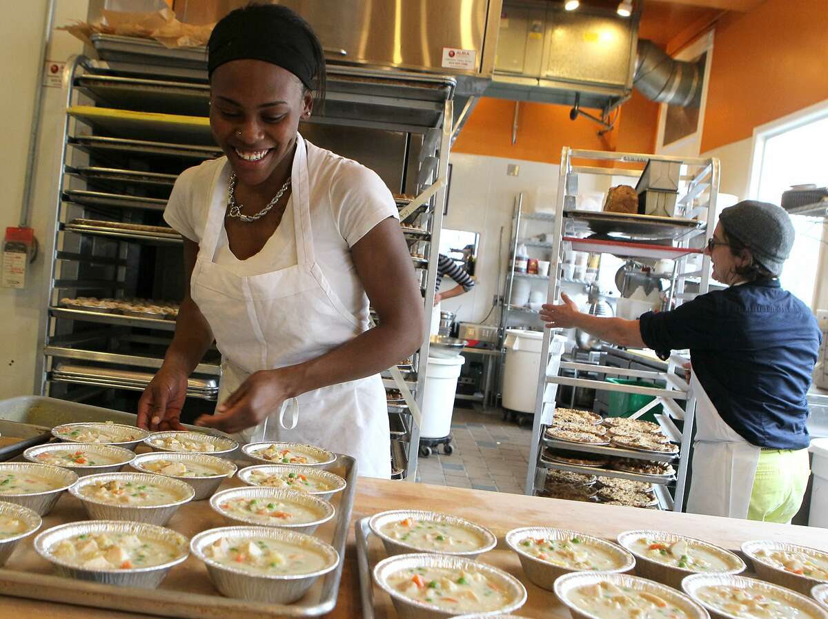 Food prep Raytrina Johnson (left) makes chicken pot pies at Mission Pie as Krystin Rubin, the stores co-owner moves a pie cart.