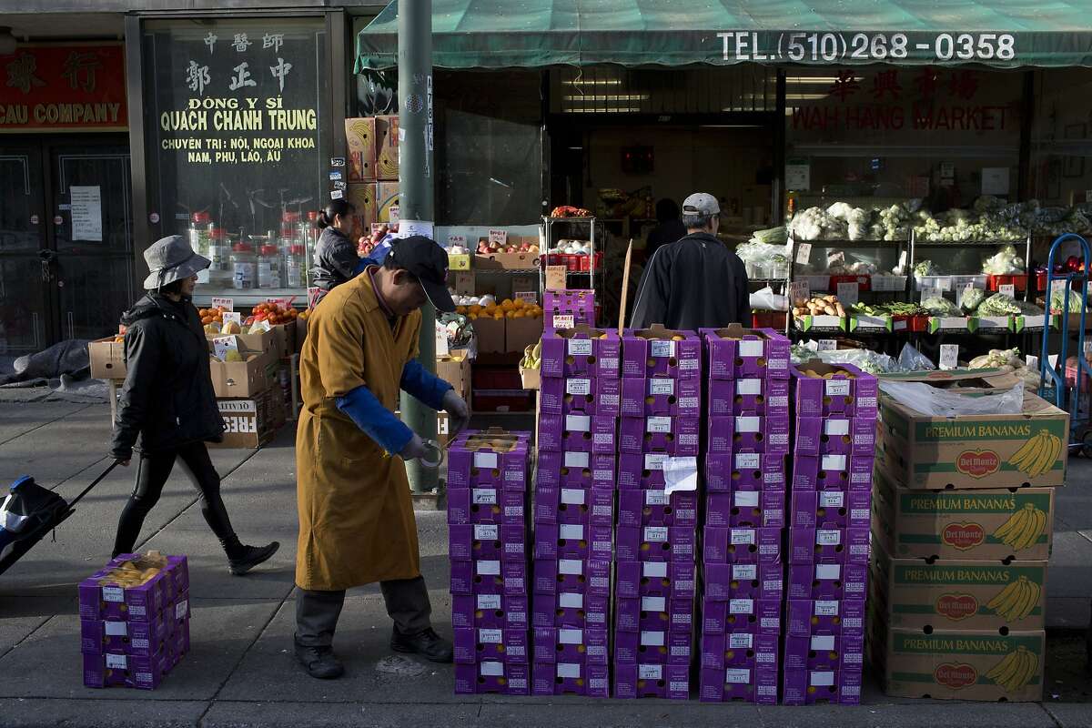 People shop at a market in Chinatown in Oakland on Friday, March 13, 2015.