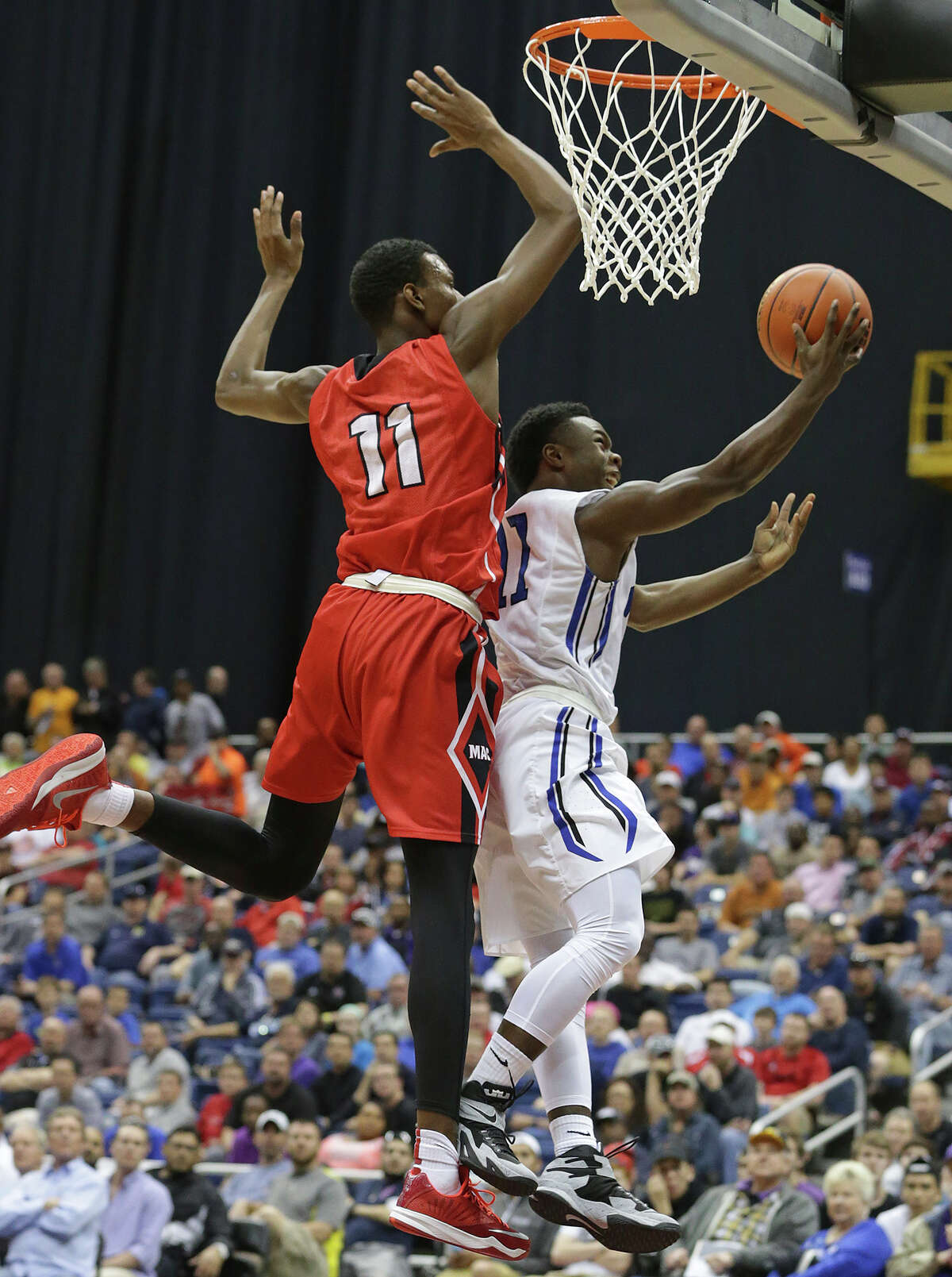 Plano West guard Derrick Aimes tries to get under Irving MacArthur defender Josh Hawley in the 6A semifinals of the UIL state basketball tournament at the Alamodome in San Antonio on March 13, 2015.