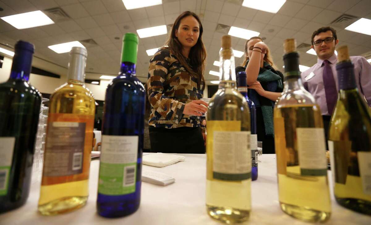 Participants at a wine-tasting event at Congregation Emanu EI sample kosher wines on Thursday.﻿