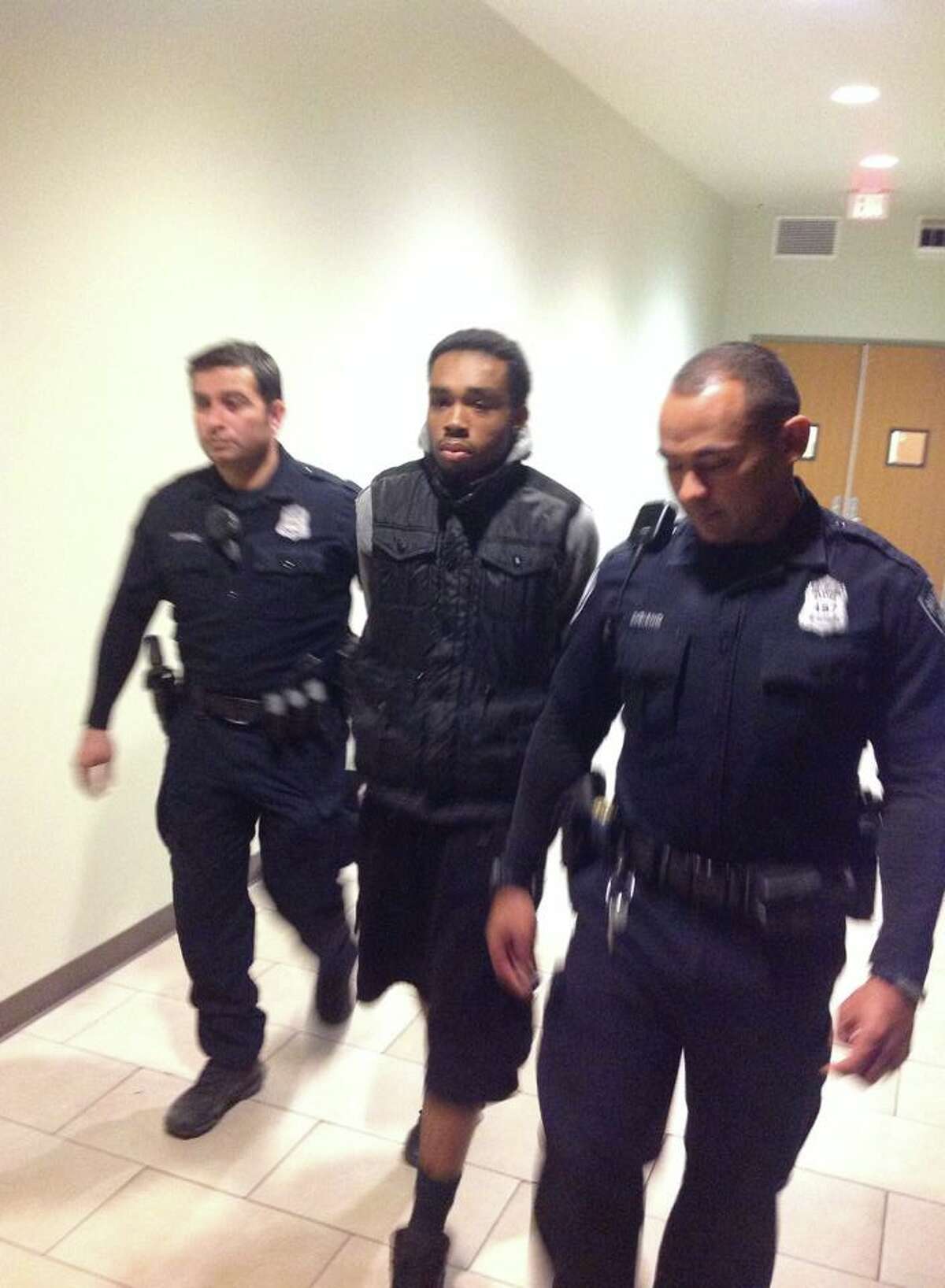 Corey Baker is escorted by San Antonio police after being arrested for suspected involvement in the shooting that killed 47-year-old Angelina Ruiz.