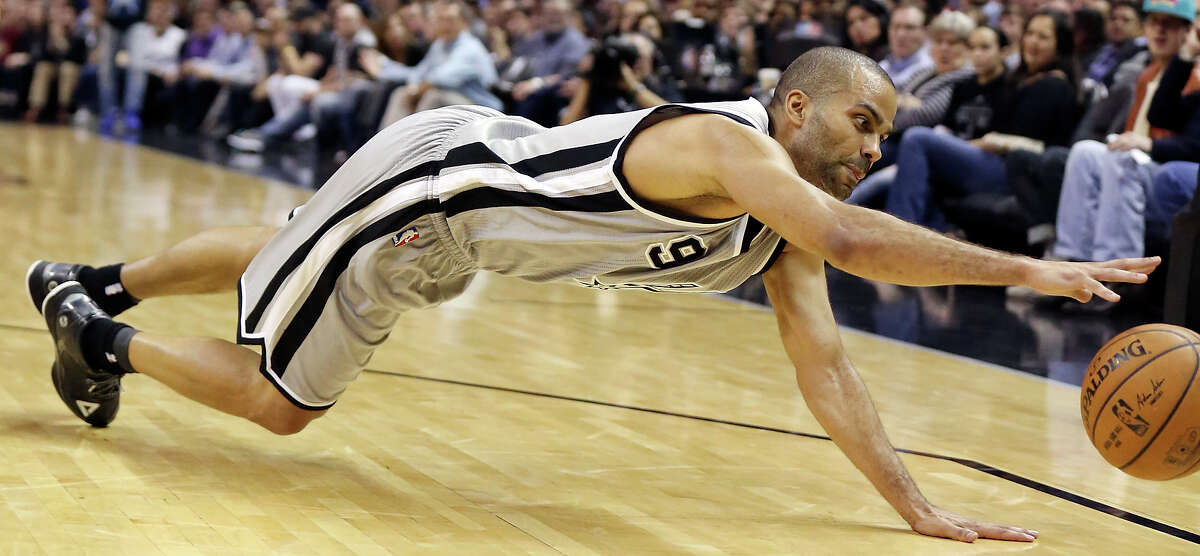 San Antonio Spurs' Tony Parker dives for a loose ball during first half action against the Cleveland Cavaliers Thursday March 12, 2015 at the AT&T Center.