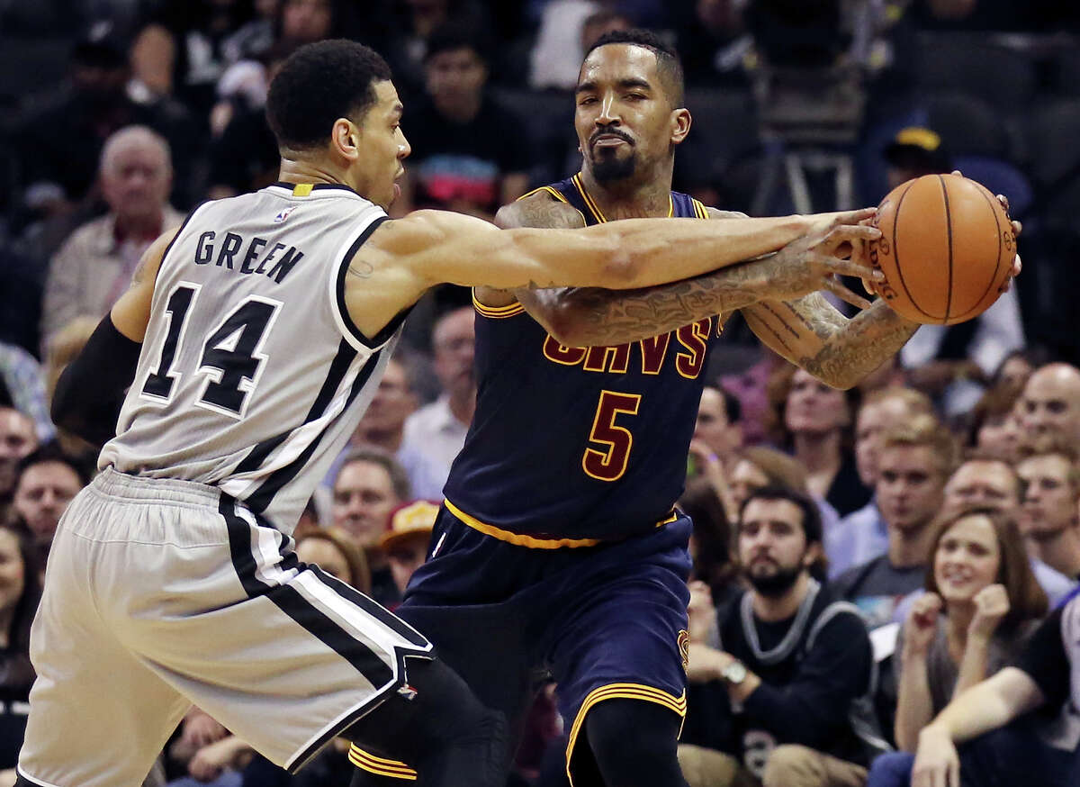 San Antonio Spurs' Danny Green defends Cleveland Cavaliers' J.R. Smith during first half action Thursday March 12, 2015 at the AT&T Center.