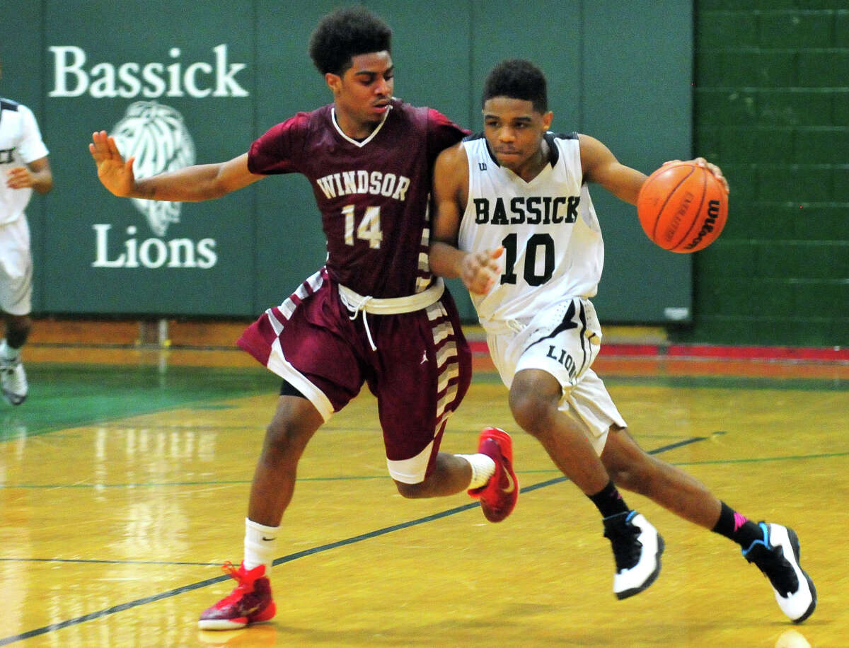 Class L Second Round of boys basketball action between Bassick and Windsor in Bridgeport, Conn. on Thursday Mar. 12, 2015. Bassick's Rajohn James tries to outpace Windsor's Eric Vinson.