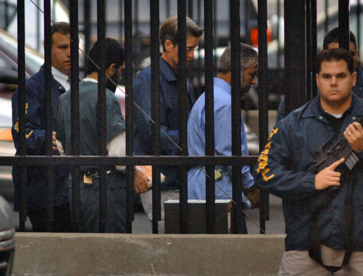 Yassin Muhiddin Aref, left, and Mohammed Hossain, right, are led away from the Federal Courthouse by U. S. Marshalls into a waiting van Tuesday evening October 10, 2006, in Albany, N.Y, following guilty verdicts in their trial. (Philip Kamrass/Times Union archive)