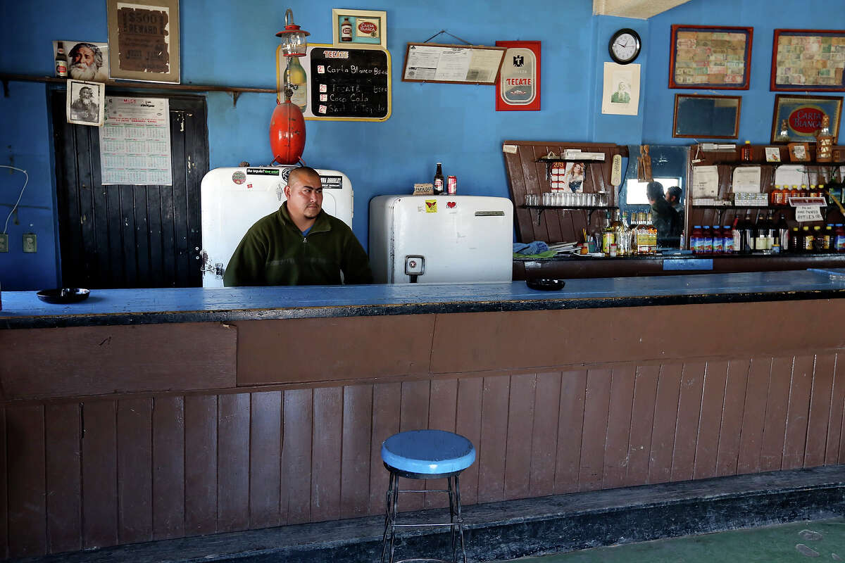Bartender Miguel Valdez waits for customers at the Park Bar Saturday March 14, 2015 in Boquillas del Carmen, Mexico. The bar is waiting to be rewired for power.