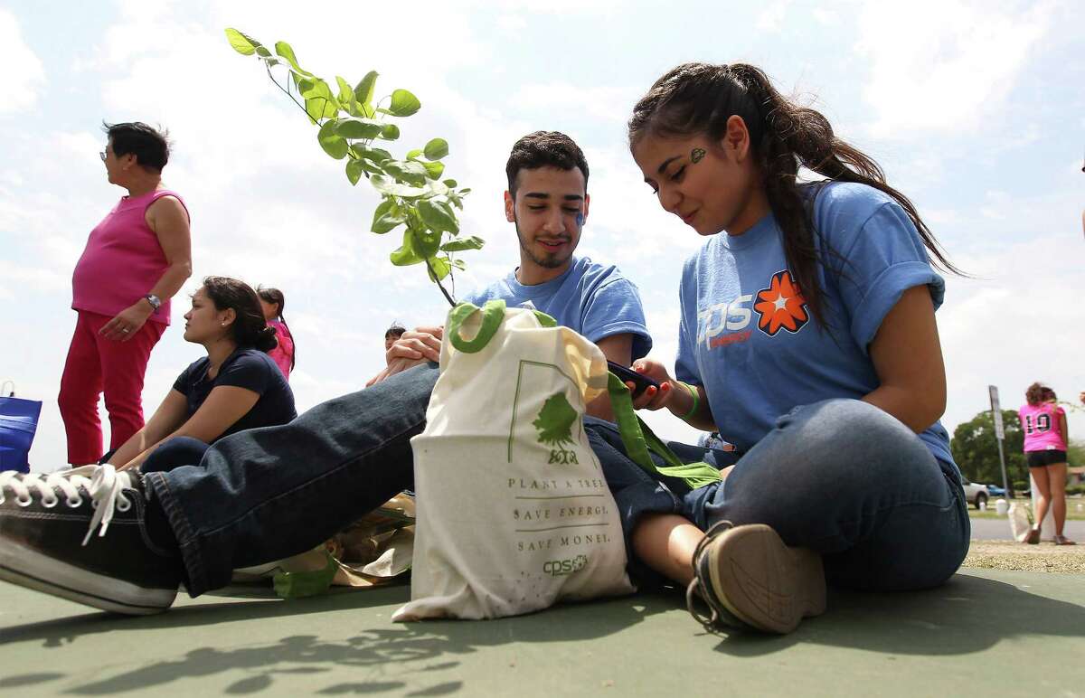 Earth Day comes March 22. It should be a time to reflect on the need to respect God’s creation. Ailyn Duran (right) and Jacob De Hoyos sit with their Redbud plant at the Earth Day Fiesta celebration at Woodlawn Lake in 2014.