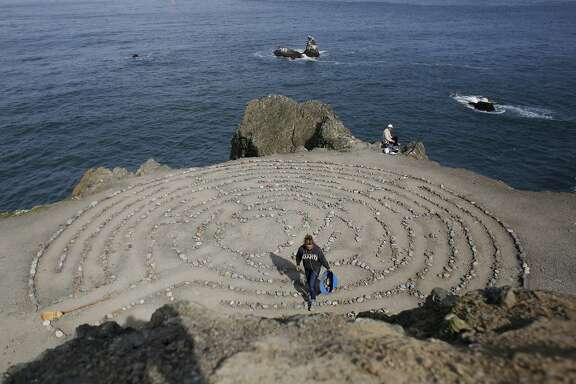 After being away on vacation, Colleen Yerge, known as the keeper of the Lands End Labyrinth, fixes up the labyrinth in San Francisco, Calif.