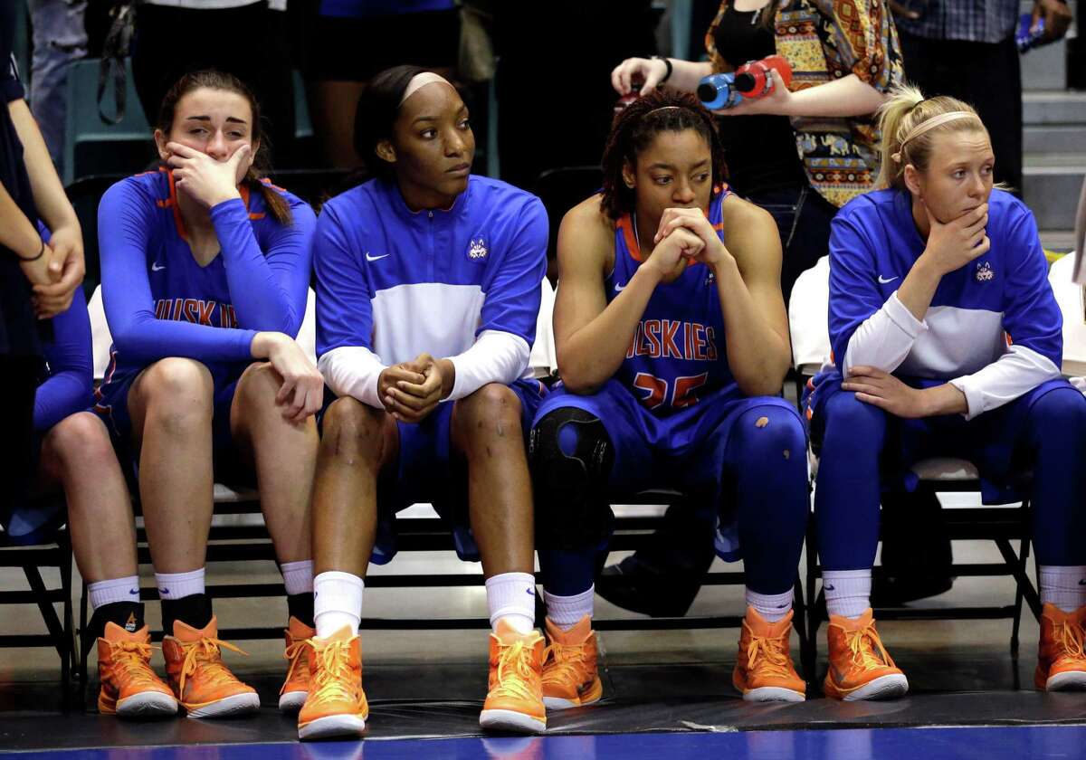Houston Baptist players sit on the bench as Northwestern State players celebrate after an NCAA college basketball game in the championship of the Southland Conference tournament Sunday, March 15, 2015, in Katy, Texas. Northwestern State won 58-50. (AP Photo/David J. Phillip)