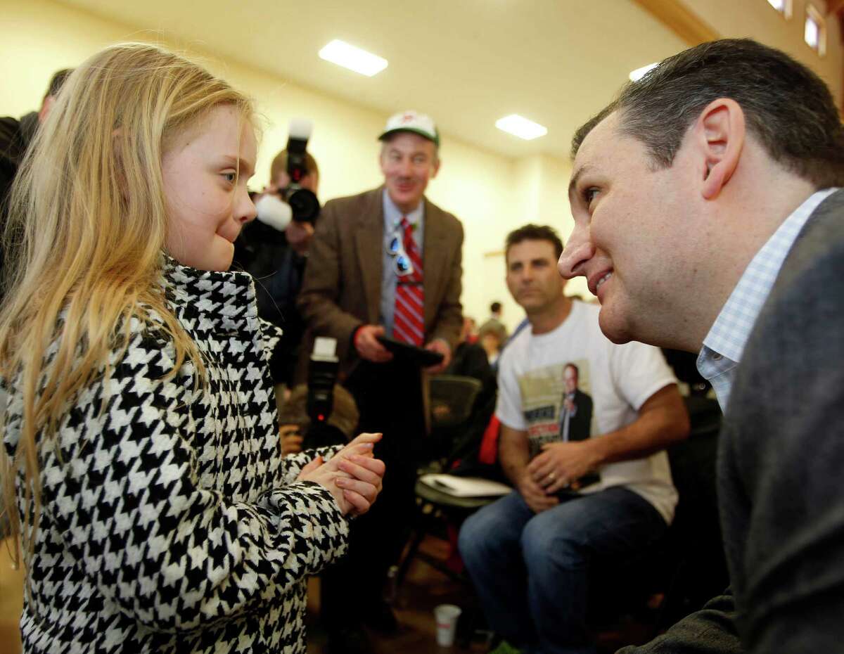 U.S. Sen. Ted Cruz, R-Texas, a tea party favorite and possible presidential candidate in 2016, speaks to Baily Ealy during a Strafford County Republican Committee Chili and Chat on Sunday, March 15, 2015, in Barrington, N.H.