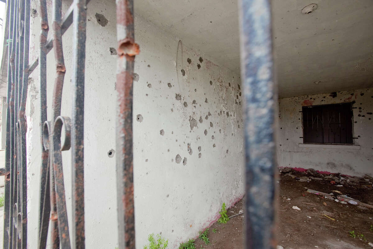 This house at Aruba Street and Matte R. Gomez Street in Matamoros, Mexico, is riddled with bullet holes after a gun fight.
