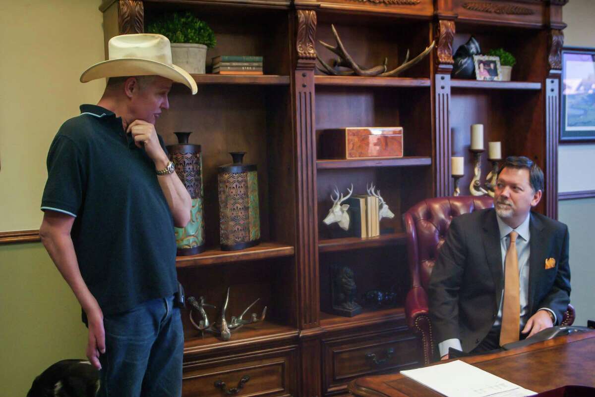 Attorney Dean Boyd, right, confers with Bobby Tunnell, whose lawsuit against a farmer over a traffic injury caused by cows is at the center of a challenge to Texas' tort reform law.