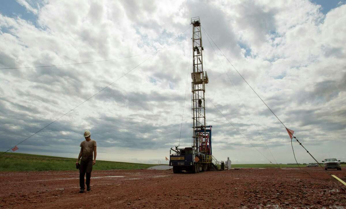 U.S. oil production is continuing to grow, even as companies are idling drilling rigs. (AP Photo/Gregory Bull, File)