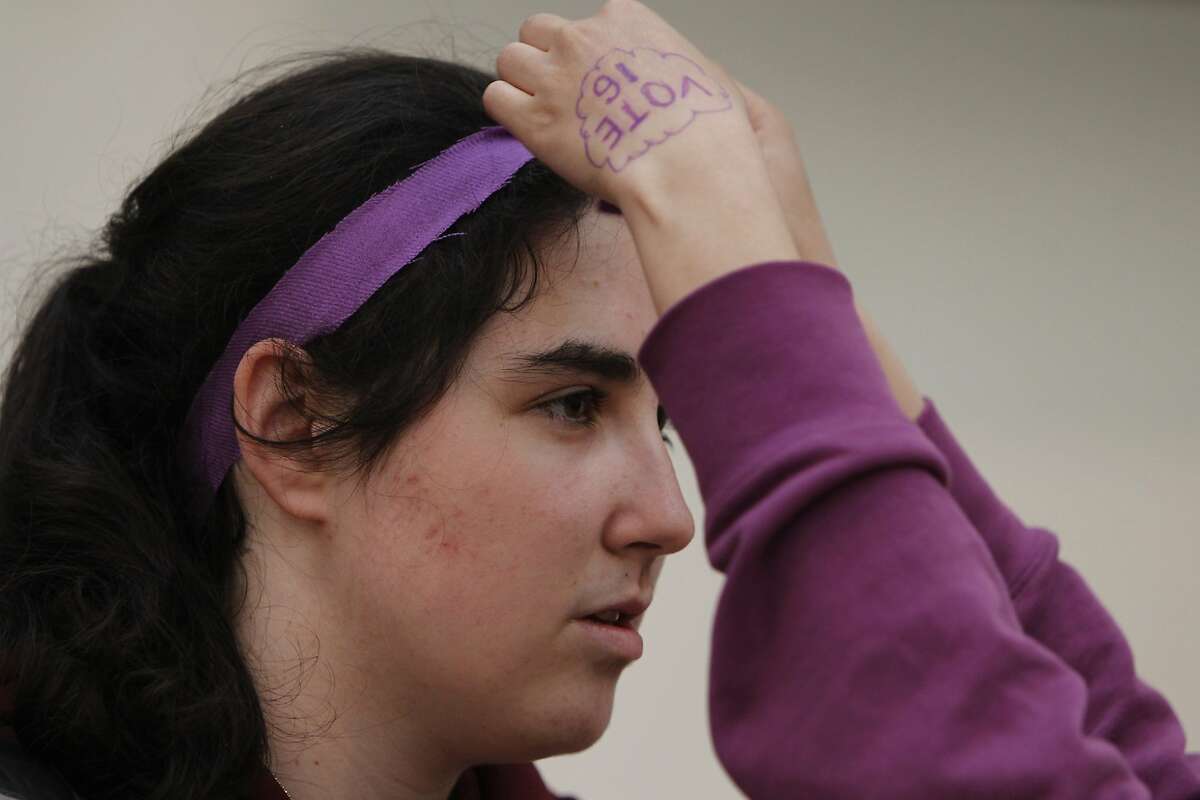 Anna He, 16, helps Anna Bernick, 17, tie a purple cloth in her hair during a rally held by the San Francisco Youth Commission at City Hall in San Francisco, Calif. Monday, March 16, 2015 to shine light on new legislation to allow 16 and 17-year-olds to vote in San Francisco. Purple is the color students in the youth commission chose to represent support for lowering the voting age.