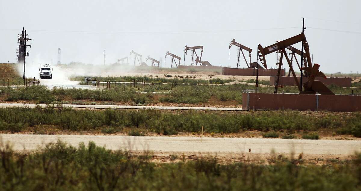 A line of oil pumps on land owned by Fasken Oil and Ranch near Midland, Texas, on Wednesday, July 23, 2014. NEXT: See photos from the Permian Basin Oil show through the years. 