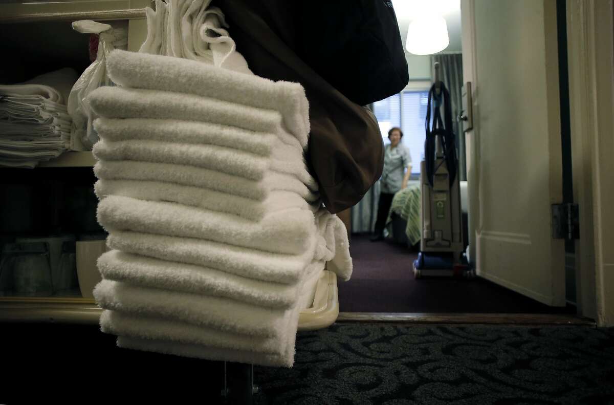 Room attendant, Caridad Rodriguez cleans a room at the Galleria Park Hotel in downtown in San Francisco, Calif., as seen on Tues. March 17, 2015. The hotel has had a green program in place for some time where guests can opt out of housekeeping and laundry service to save water.