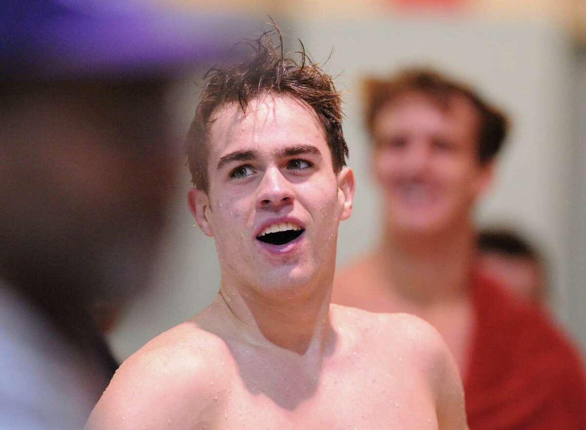 At center, Iain Edmundson of Greenwich after winning the 100 yard breaststroke event during the boys high school Class LL state swimming championships at Wesleyan University in Middletown, Conn., Tuesday, March 17, 2015.