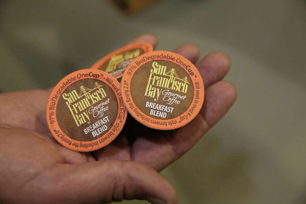 In this photo taken Wednesday, March 4, 2015 John Rogers displays single-serve coffee pods at the Rogers Family Company in Lincoln, Calif. The Rogers company, coffee roasters who among other products, makes biodegradable single-serve coffee pods for use in the Keurig Green Mountain's single-serve coffee machines. The Rogers company is one of more than a dozen-coffee-makers and other businesses suing Keurig over what they claim is Keurig's unfair trade efforts to shut out competing single-serve coffee rivals.(AP Photo/Rich Pedroncelli)