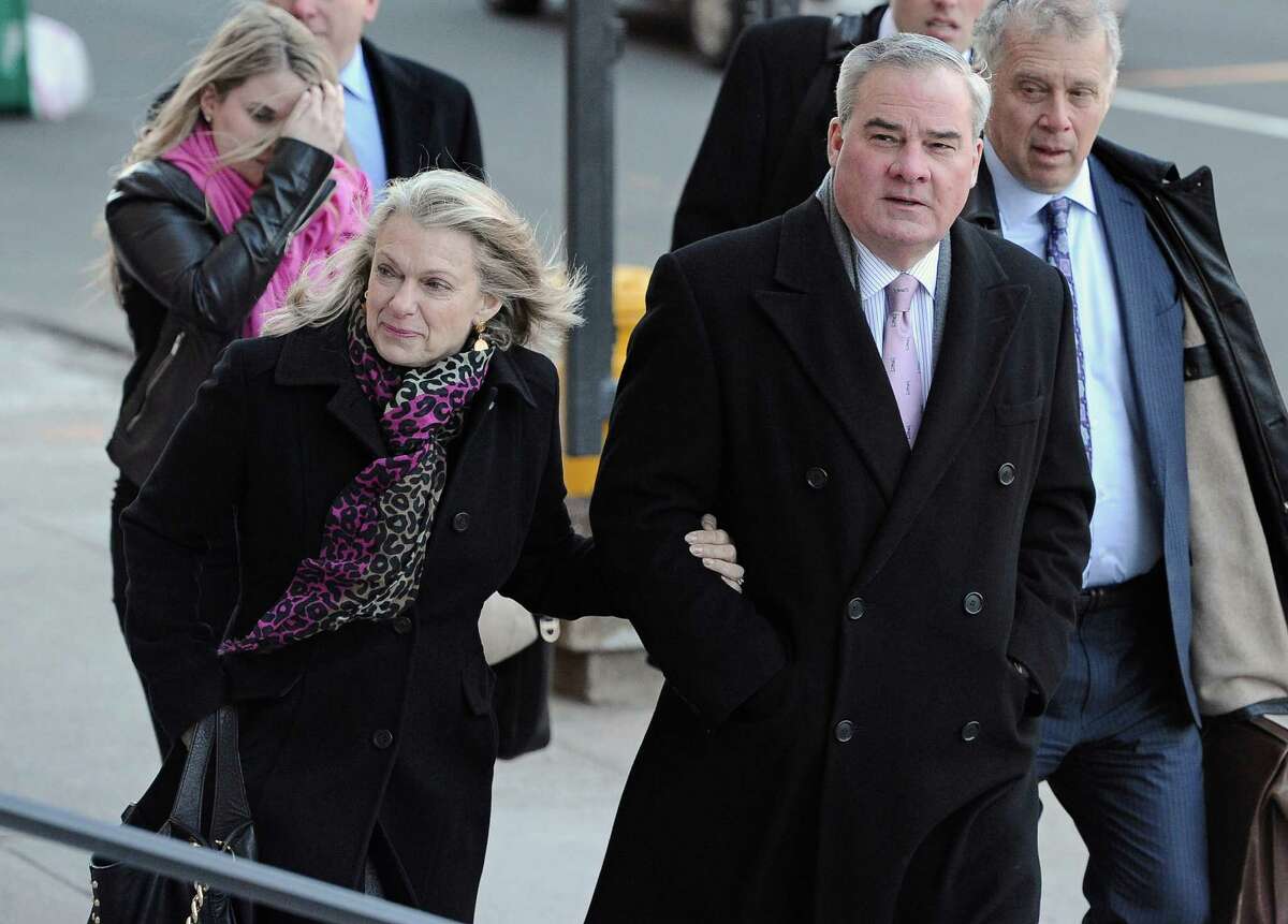 Former Connecticut Gov. John Rowland arrives with his wife Patty Rowland, left, at federal court in New Haven, Wednesday, March 18, 2015, in New Haven, Conn. A federal court jury in New Haven convicted Rowland in September of federal charges that he conspired to hide payment for work on two congressional campaigns. His sentencing on Wednesday will come 10 years to the day that he was sentenced to a year and a day in prison for accepting illegal gifts while in office, including trips and improvements to his lakeside cottage.