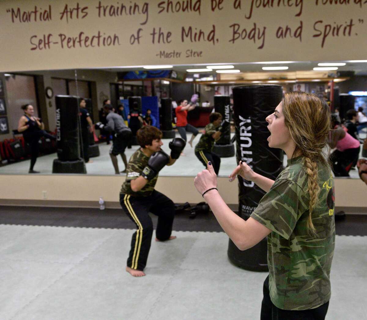 Instructor Lyndsay Doyon shouts encouragement to her KickFit class at Connecticut Martial Arts - Danbury Martial Arts Training Center on Wednesday, March 18, 2015, in Danbury, Conn.