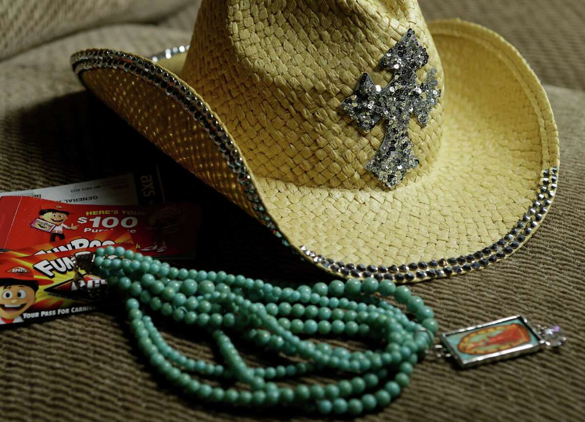 A hat, necklace and $100.00 in carnival passes are shown Wednesday, March 18, 2015, in La Porte that were purchases made by the Cody family of La Porte during their visit to the Houston Livestock Show and Rodeo. John Cody, his wife, Maricruz Cody, and their children, Abigail, 15, Celeste, 11, and Sarah, 8, were detained and questioned during their visit to the Houston Livestock Show and Rodeo for allegedly shoplifting.