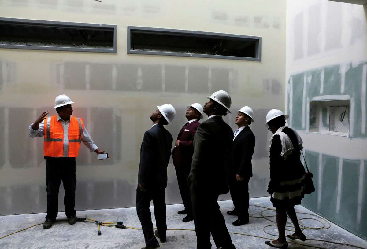 Former Mayor Willie Brown (center), and city and school district officials, admire a skylight in the new Willie Brown Middle School in the Bayview Neighborhood of San Francisco on Thursday, March 19, 2015. Brown's visit came as district officials were announcing assignment numbers for the school this fall.