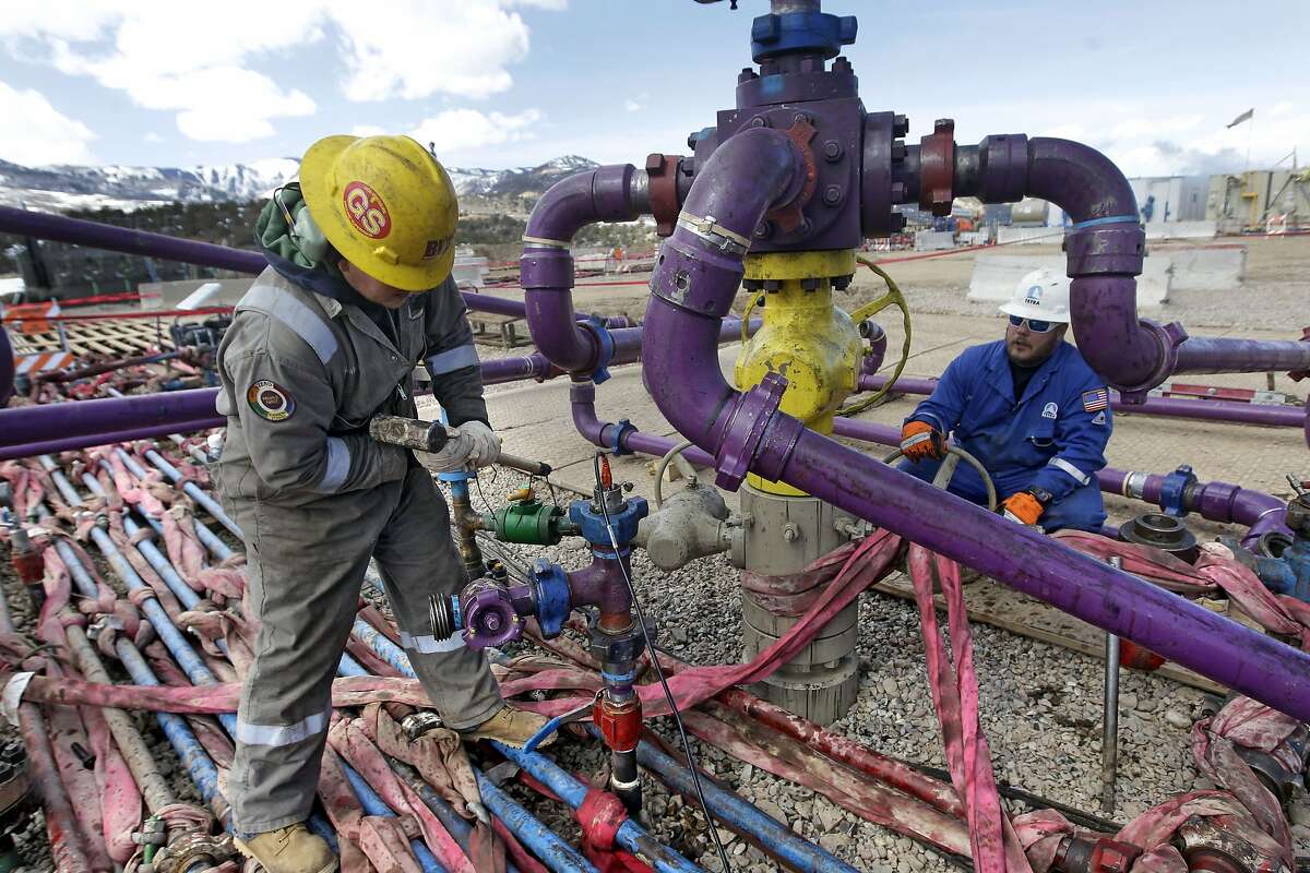 In this March 29, 2013 file photo, workers tend to a well head during a hydraulic fracturing operation at an Encana Oil & Gas (USA) Inc. gas well outside Rifle, in western Colorado. The Obama administration is proposing a rule that would require companies that drill for oil and natural gas on federal lands to publicly disclose chemicals used in hydraulic fracturing operations. The new "fracking" rule replaces a draft proposed last year that was withdrawn amid industry complaints that federal regulation could hinder an ongoing boom in natural gas production. (AP Photo/Brennan Linsley, File)