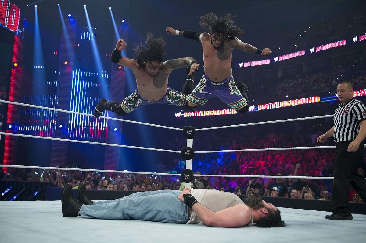 WWE Superstars Jimmy and Jey Uso deliver a top rope splash on Luke Harper. The Usos will be a part of WrestleMania 31 at Leviâ€™s Stadium.