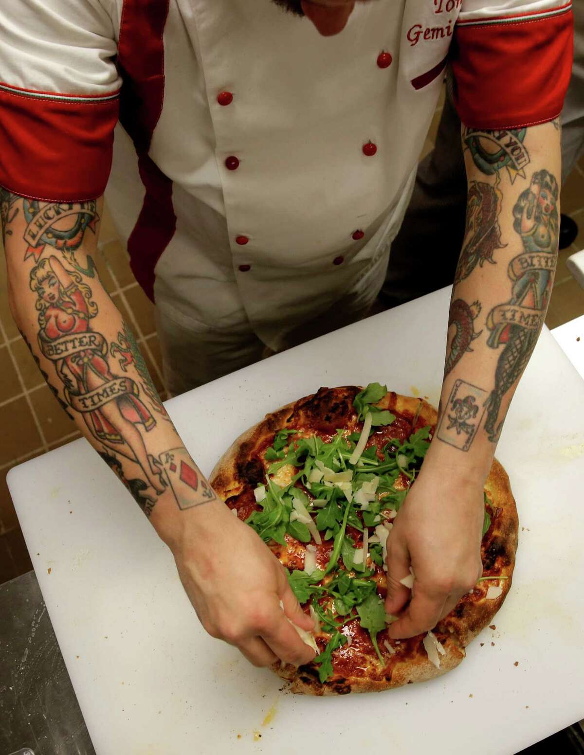 2015年3月11日星期三，在位于美国内华达州亨德森的最新比萨岩餐厅，Tony Gemignani向他的厨房员工演示如何正确准备他获奖的披萨。