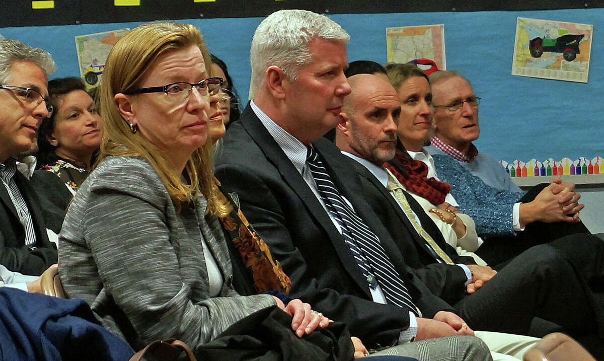 School administrators listen as the Representative Town Meeting discusses its contract. The contract, rejected by the RTM in December, was approved.
