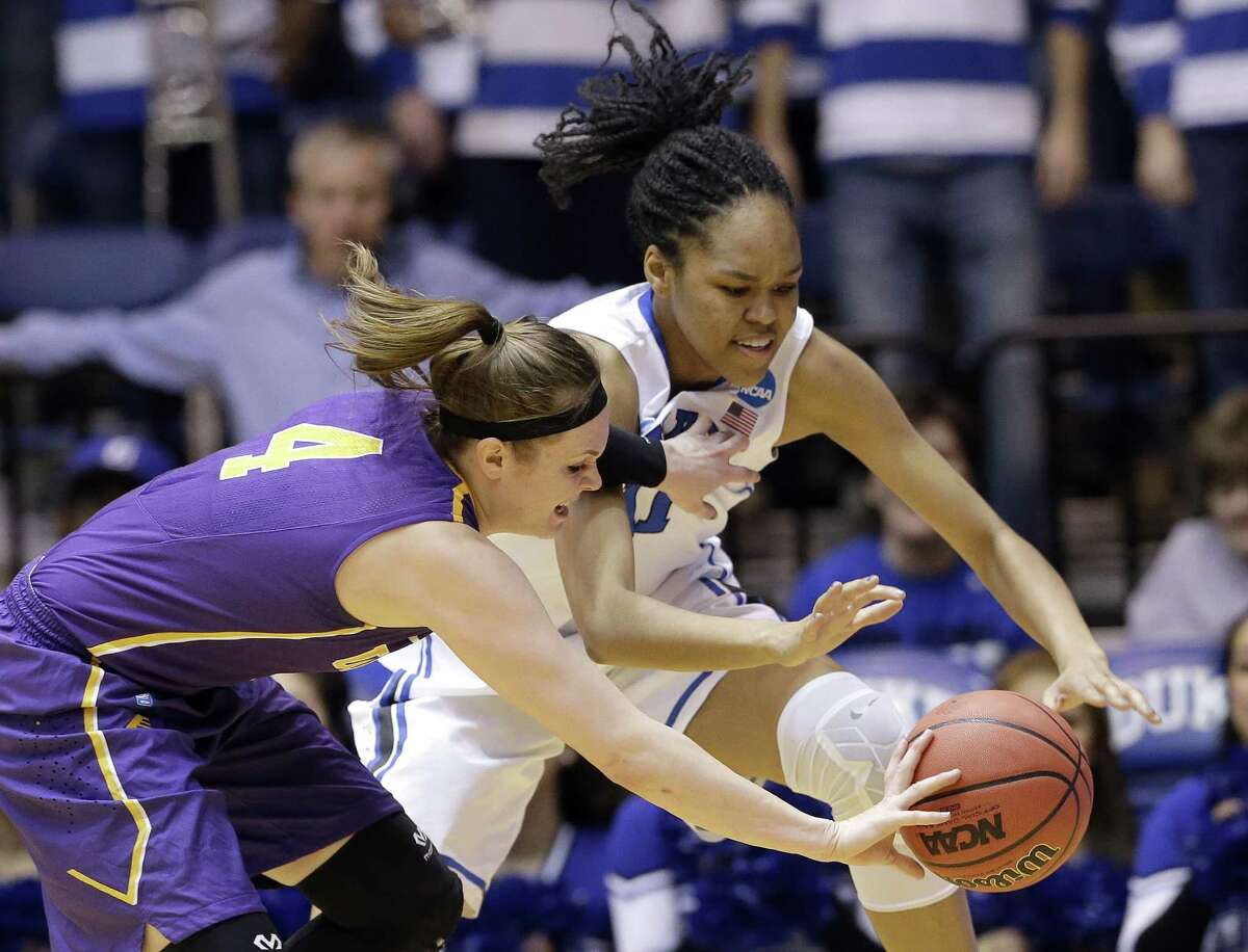 Albany's Sarah Royals (4) and Duke's Azura Stevens reach for the ball during the first half of a women's college basketball game in the first round of the NCAA tournament in Durham, N.C., Friday, March 20, 2015. (AP Photo/Gerry Broome) ORG XMIT: MER2015032012564078