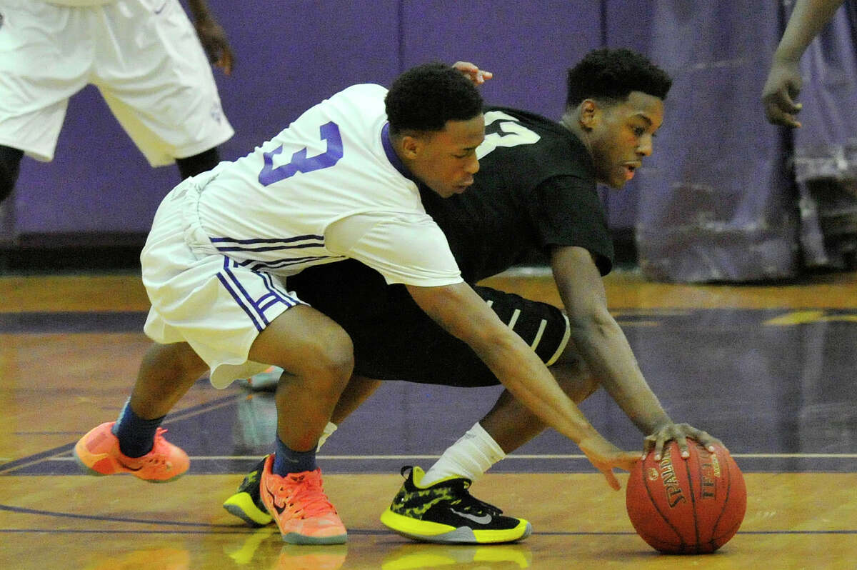 Westhill's CJ Donaldson and East Hartford's Tariq Ricketts go for the loose ball during their Class LL second round state tournament game at Westhill High School in Stamford, Conn., on Wednesday, March 11, 2015. Westhill won, 49-47.