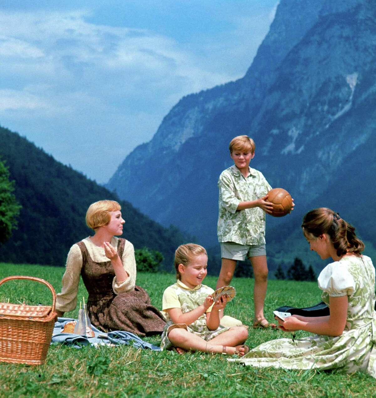 Maria (Julie Andrews, left), Gretl (Kym Karath), Kurt (Duane Chase) and Liesl (Charmian Carr) sing “Do-Re-Mi” in “The Sound of Music,” a movie that evokes a simpler time but was released in 1965, a period of tumultuous change.