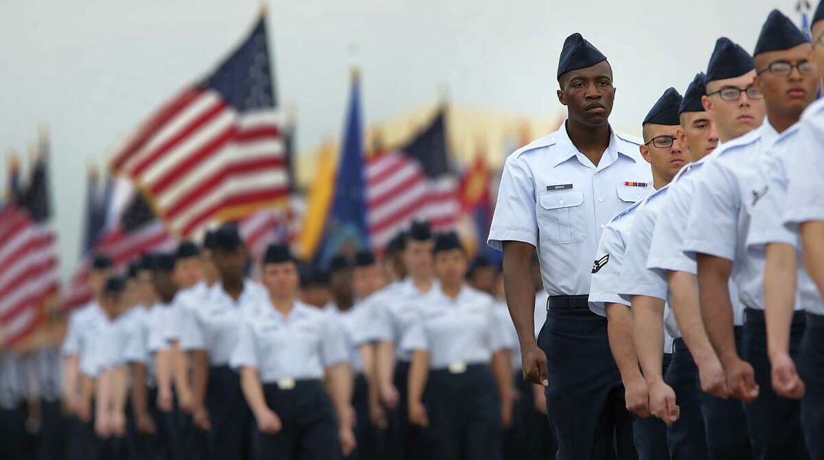 A flight of airmen marches before commanders, family and friends. The change in basic training came in the wake of an instructor misconduct scandal.