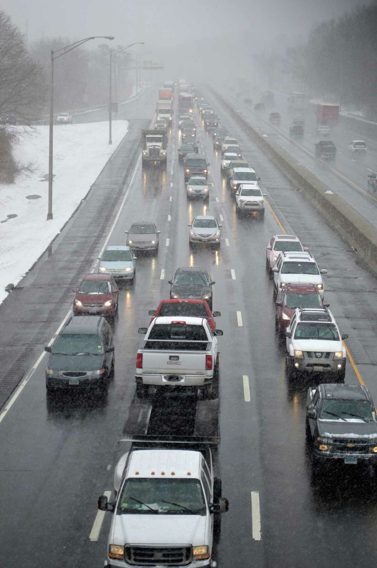 Traffic crawled along Interstate 95 through town as snow fell on the first day of spring.