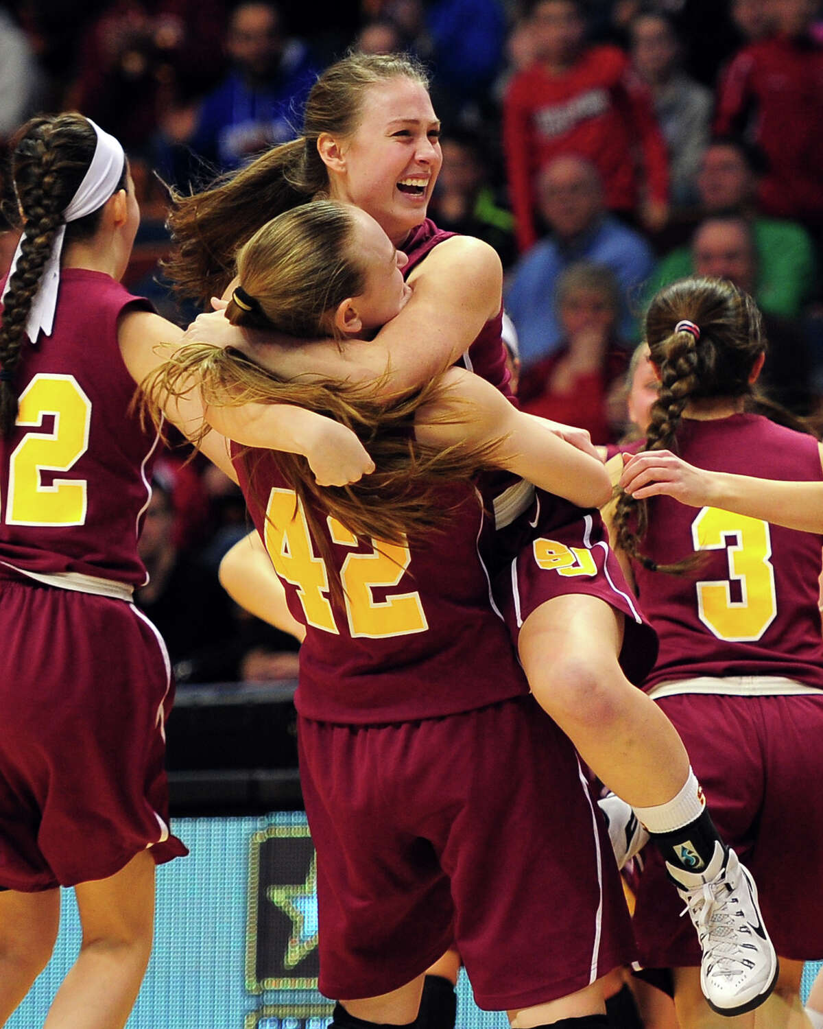 St. Joseph's Jacqueline Jozefick (42) and Erika Horvath hug as they celebrate beating Cromwell, during CIAC State Girls Basketball Tournament action at Mohegan Sun in Uncasville, Conn., on Saturday Mar. 21, 2015.