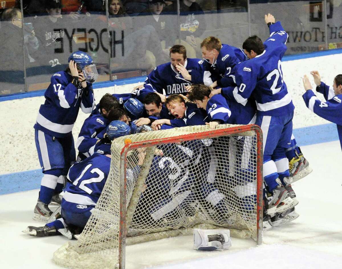 The Darien High School boys hockey team celebrates their 1-0 CIAC Division I boys state hockey championship victory over Greenwich High School at Ingalls Rink in New Haven, Conn., Saturday March 21, 2015. Darien took the title with a 1-0 victory over Greenwich on a Jack Pardue goal in the second period.