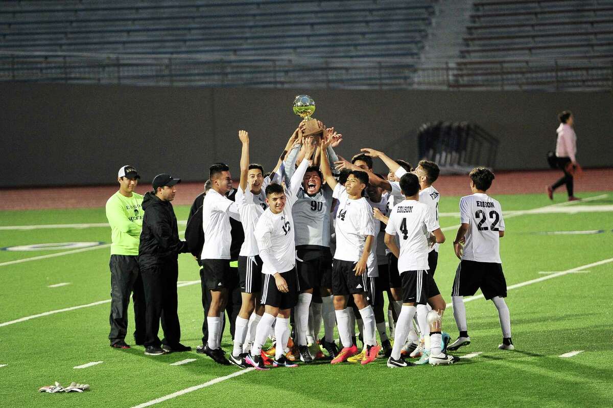 The Edison Golden Bears hoist the district championship trophy after defeating Jefferson High School 3 - 0 during the District 28-5A Championship match at Alamo Stadium in San Antonio, Tx. on Saturday, March 21, 2015.