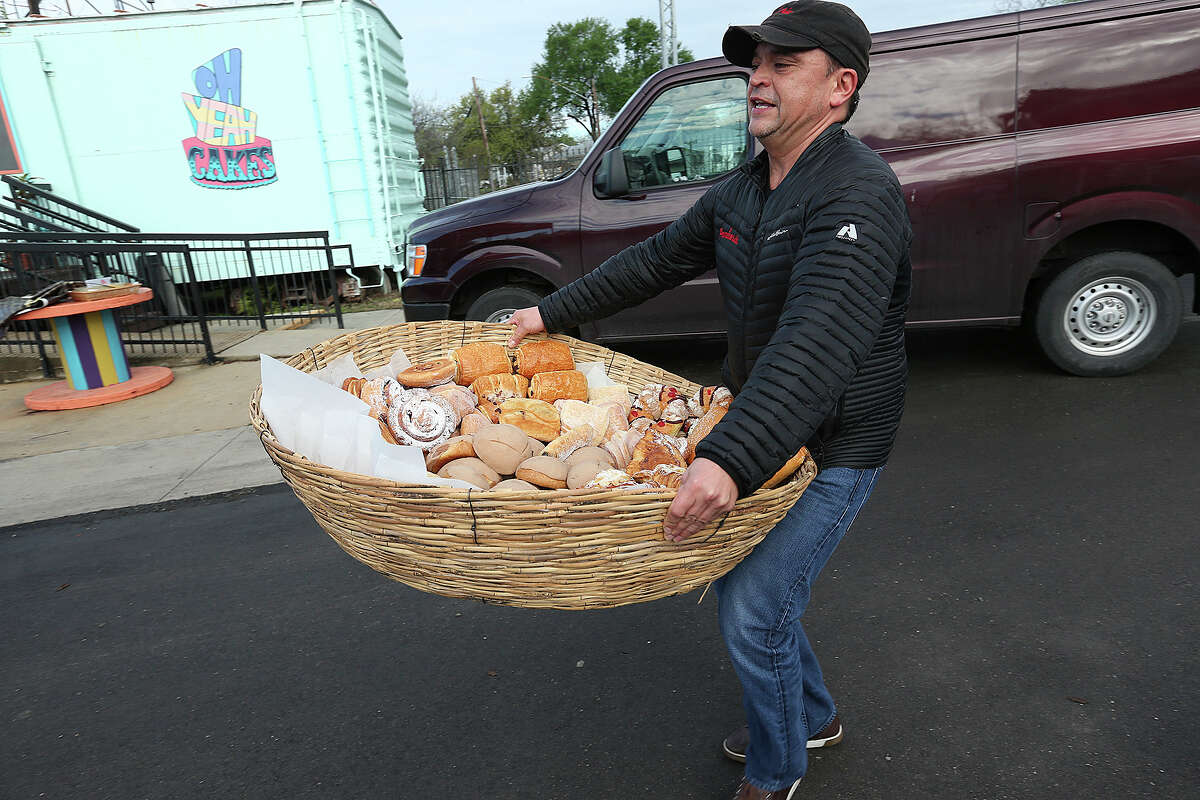 Jose Caceres, of La Panaderia, arrives with baskets full of bread at the Yard Farmers and Ranchers Market on Sunday, March 22, 105. Last week a controversy over racist remarks made by the market's owners led to at least six vendors leaving.