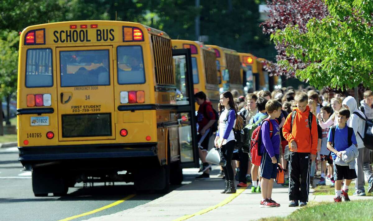 Buses are lined up at the end of the school day at Scotts Ridge Middle School in Ridgefield, Conn., Tuesday, Sept. 23, 2014.