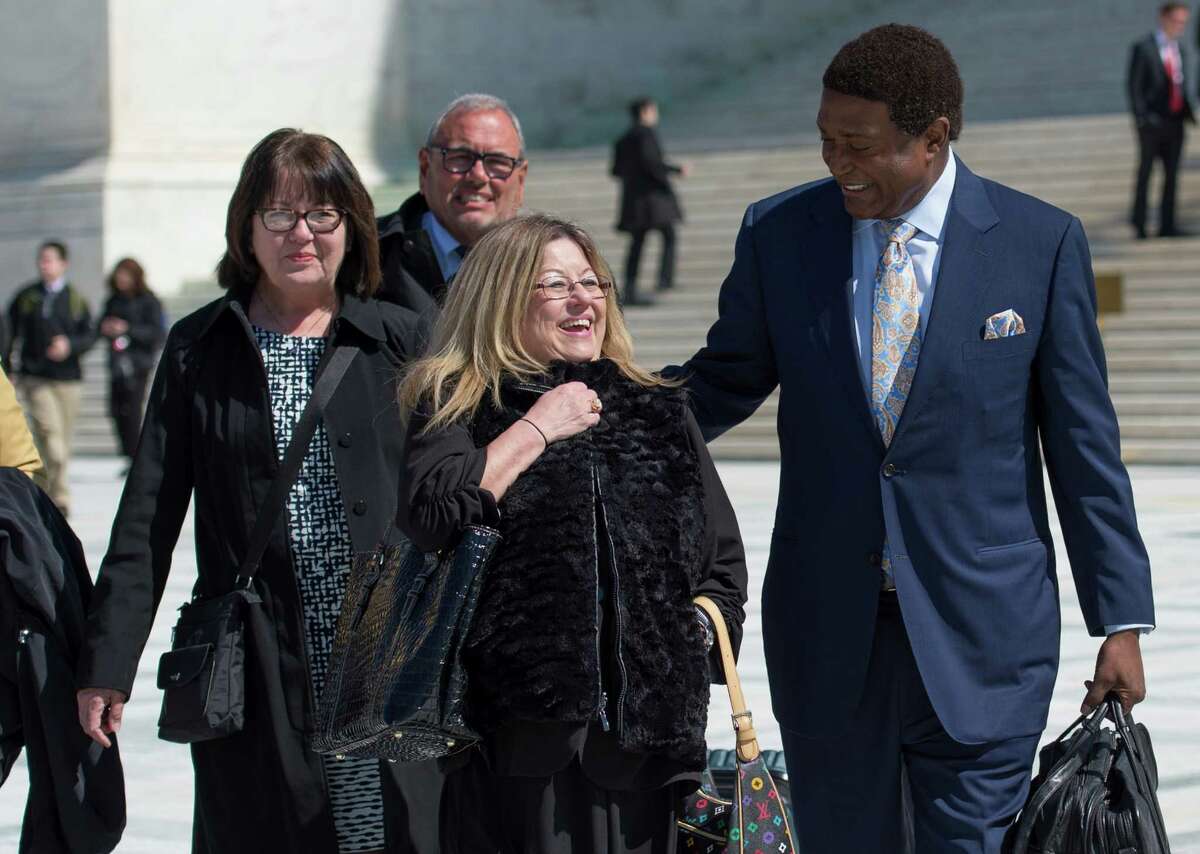 Frances Sheehan (left) and Joanne Sheehan leave the Supreme Court building with lawyer John Burris, who is representing their sister Teresa.