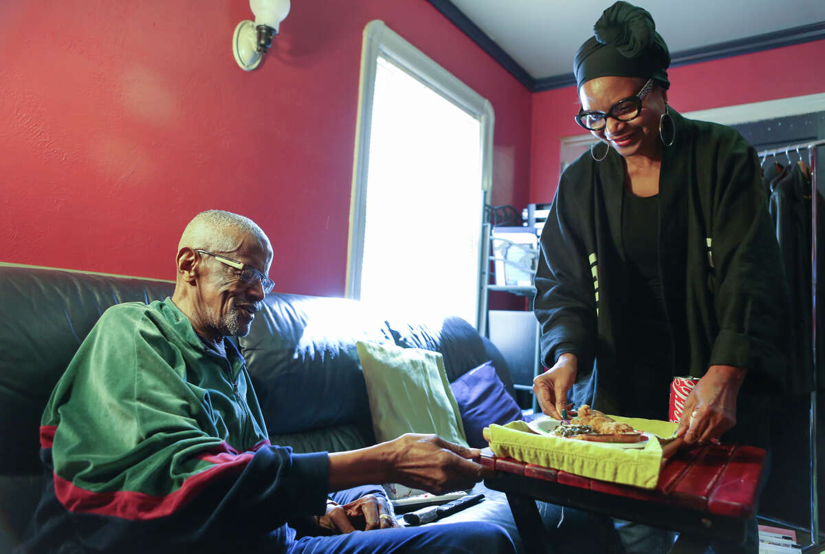 Chris Mason of Oakland serves lunch to her husband, Nathaniel. “He functions well but ... it’s like taking care of a child,” she says of the 85-year-old, diagnosed with Alzheimer’s in 2013.