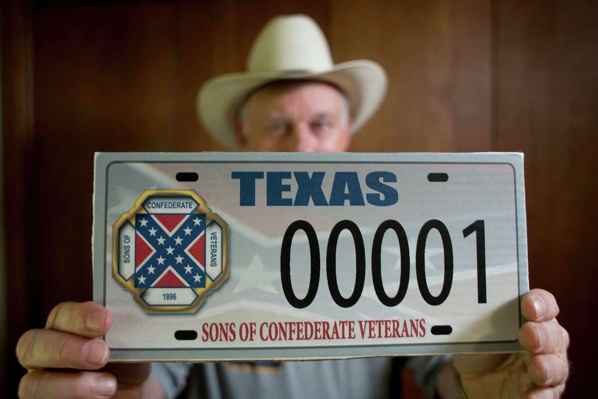 Ray James, a member of the Texas chapter of the Sons of Confederate Veterans, displays a license plate with the Confederate "battle flag."