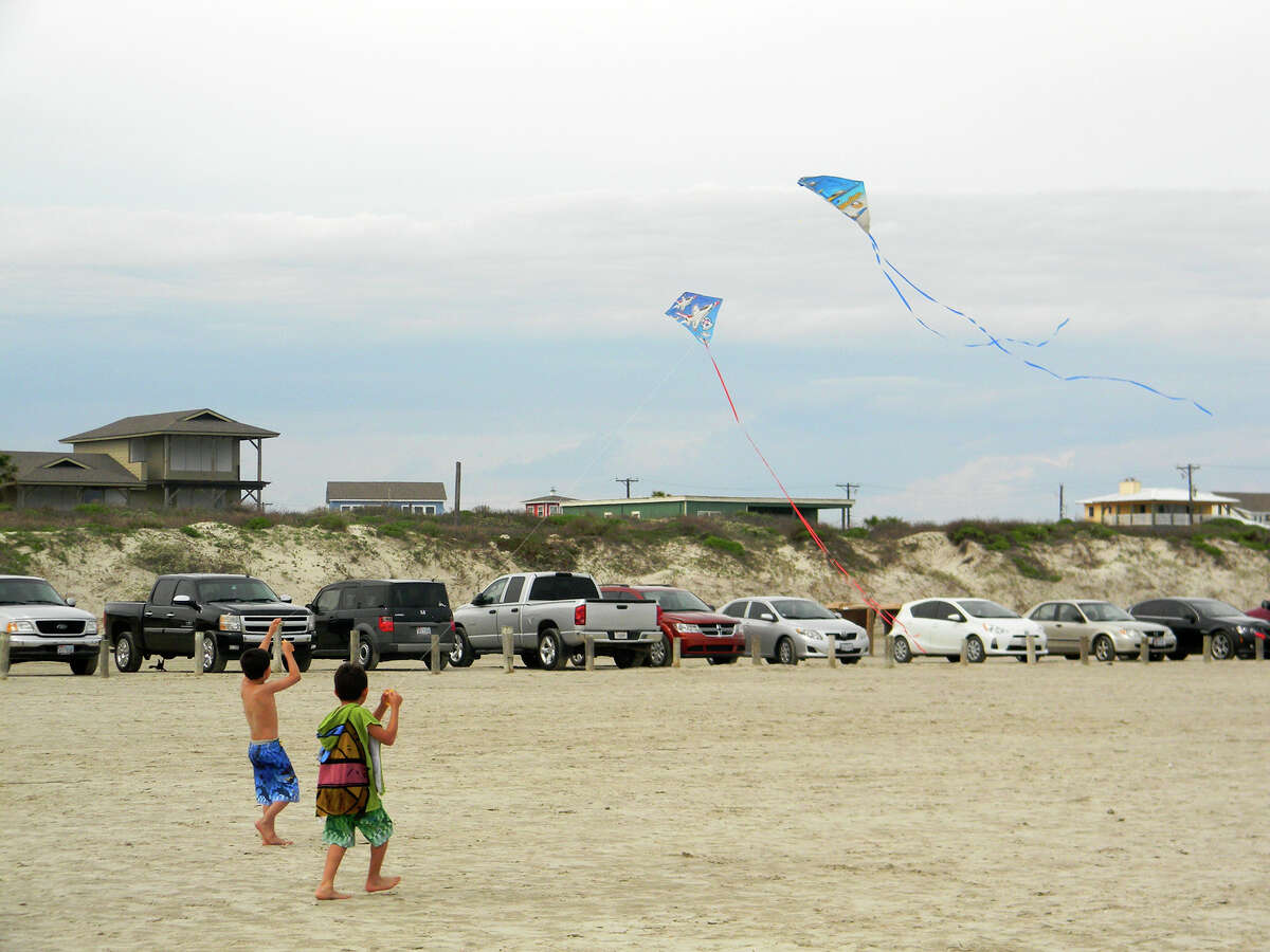 Two boys fly kites on the beach at Port Aransas.