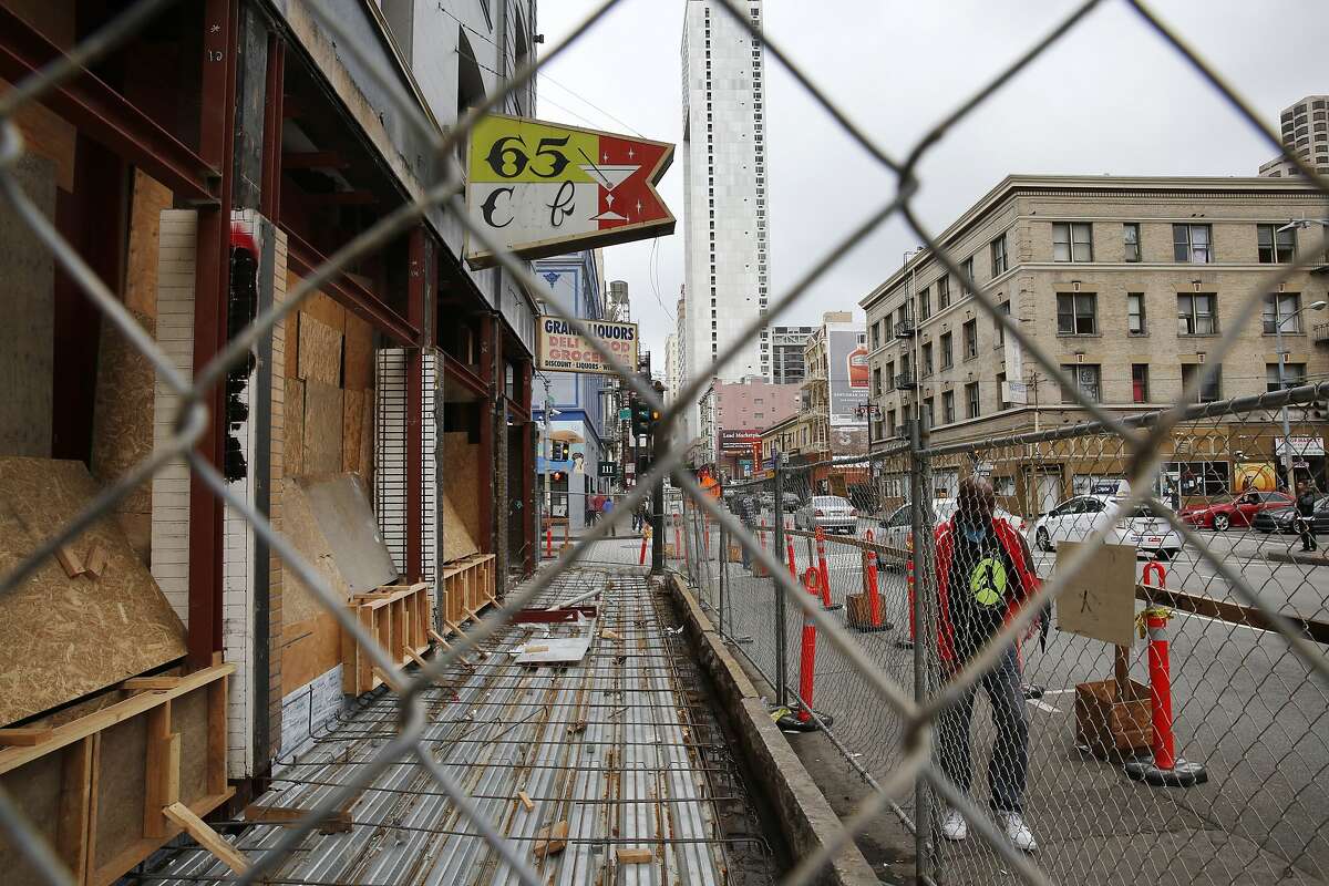 A pedestrian walks past a construction site of a future restaurant in the Tenderloin on Taylor and Turk Streets March 24, 2015 in San Francisco, Calif. Chefs Daniel Patterson and Roy Choi are starting a new restaurant on Turk and Taylor with the intent on serving inexpensive, sustainable and delicious food that is accessible to the local community.