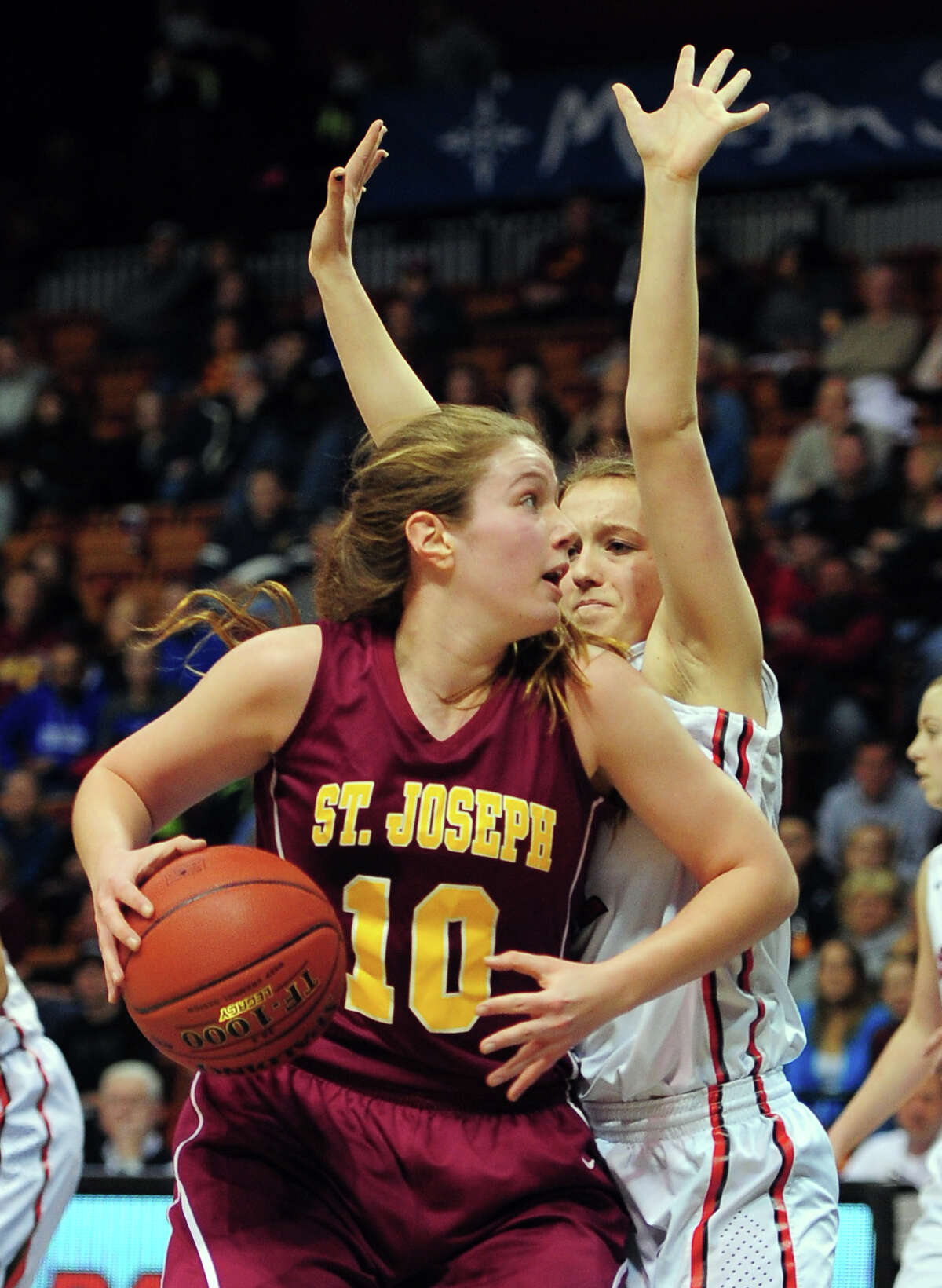 St. Joseph's Bridget Sharnick tries to get around Theresa Quinn, right, during CIAC State Girls Basketball Tournament action at Mohegan Sun in Uncasville, Conn., on Saturday Mar. 21, 2015.