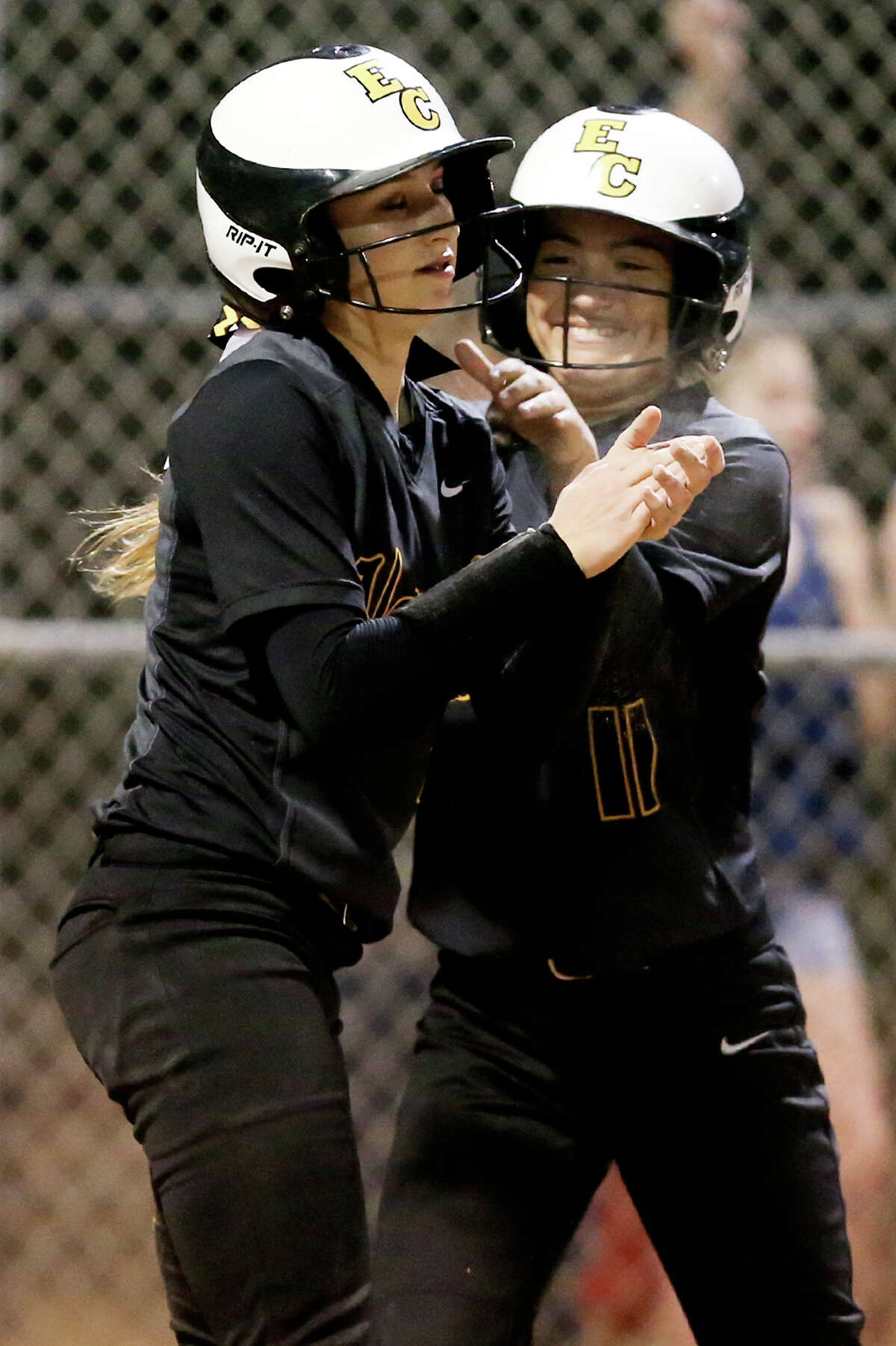 East Central's Cara Johnson (right) celebrates with Kendall Talley after the pair scored in the fifth inning of their District 28-6A softball game at East Central on Tuesday, March 24, 2015. East Central beat Southwest 4-2. MARVIN PFEIFFER/ mpfeiffer@express-news.net