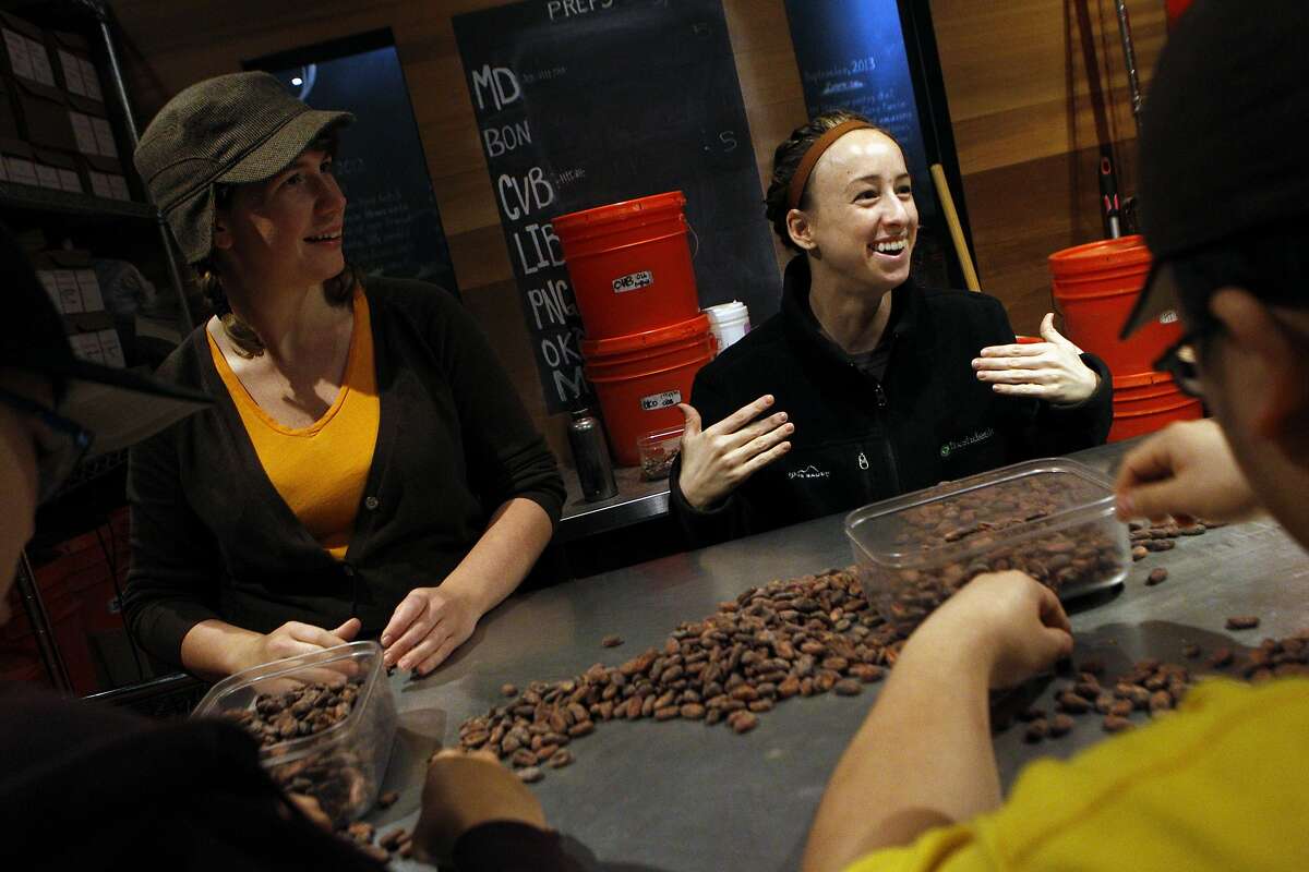 Olivia Yenzer (right), chocolate maker, and January Coleman-Jones, production manager, sort out chocolate beans for any defects and unwanted items, Tuesday, March 24, 2015, in San Francisco, Calif.