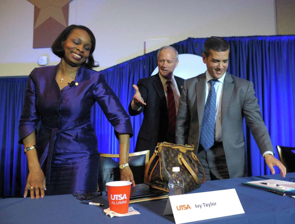 Former Bexar County Commissioner Tommy Adkisson, second from left, offers a handshake to Mayor Ivy Taylor as former state Rep. Mike Villarreal stands by after a mayoral debate at UTSA on Wednesday, March 25, 2015.