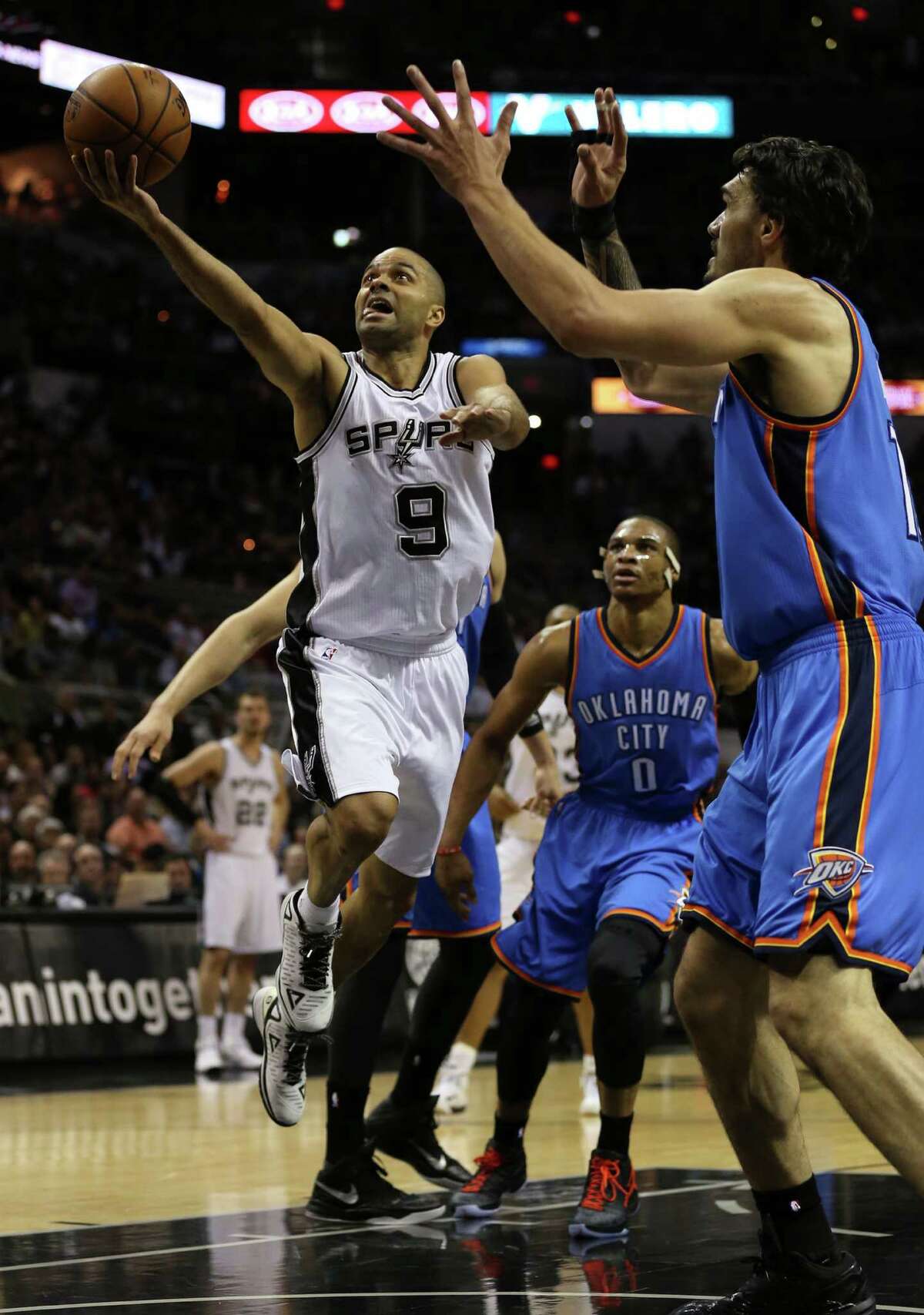 San Antonio Spurs' Tony Parker drives to the basket as Oklahoma City Thunder's Steven Adams defends during the first half at the AT&T Center, Wednesday, March 25, 2015.